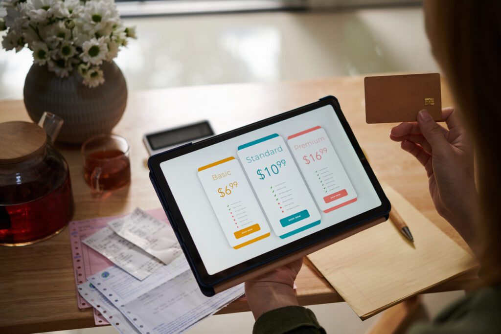 Subscription management tools: A customer paying for a service subscription on his digital tablet