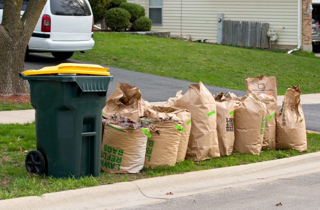 Subscription management tools: Brown bags full of compost materials on the curbside for pick-up