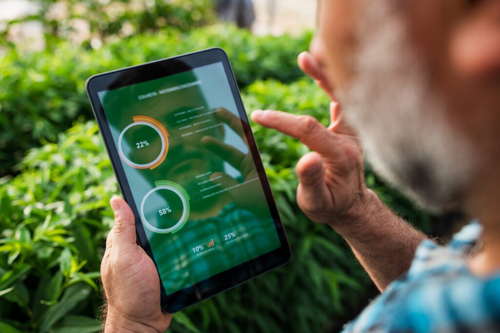 Farmer uses his tablet to manage produce output and deliveries.