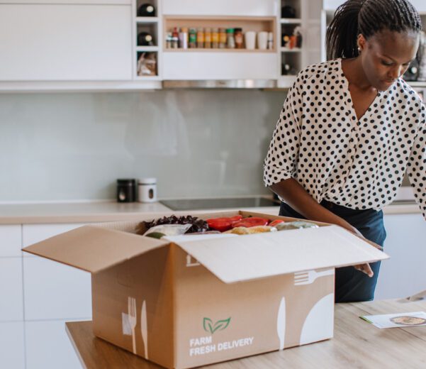 Woman opens perishable package of shipped frozen goods.