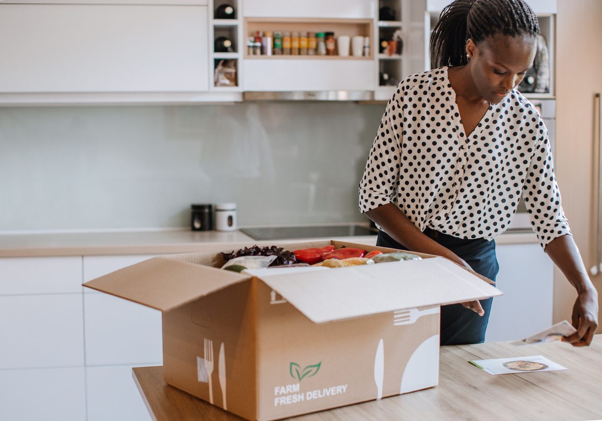 Woman opens perishable package of shipped frozen goods.