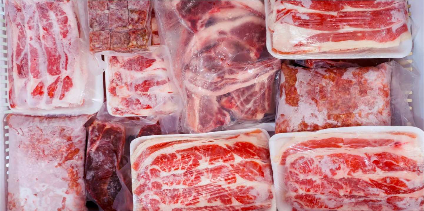 Vacuum-sealed frozen beef cuts, steaks and ground beef packed in a freezer